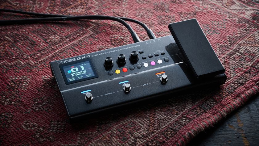 A Boss GX-1 multi-effects pedal on a worn rug