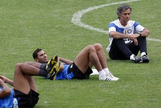 Inter Milan manager Jose Mourinho (R) looks on while Ricardo Quaresma and players warm up during a training session ahead of their Italian Super Cup match against Lazio on August 4, 2009 in Beijing, China. (Photo by Yin Lan/Visual China Group via Getty Images)