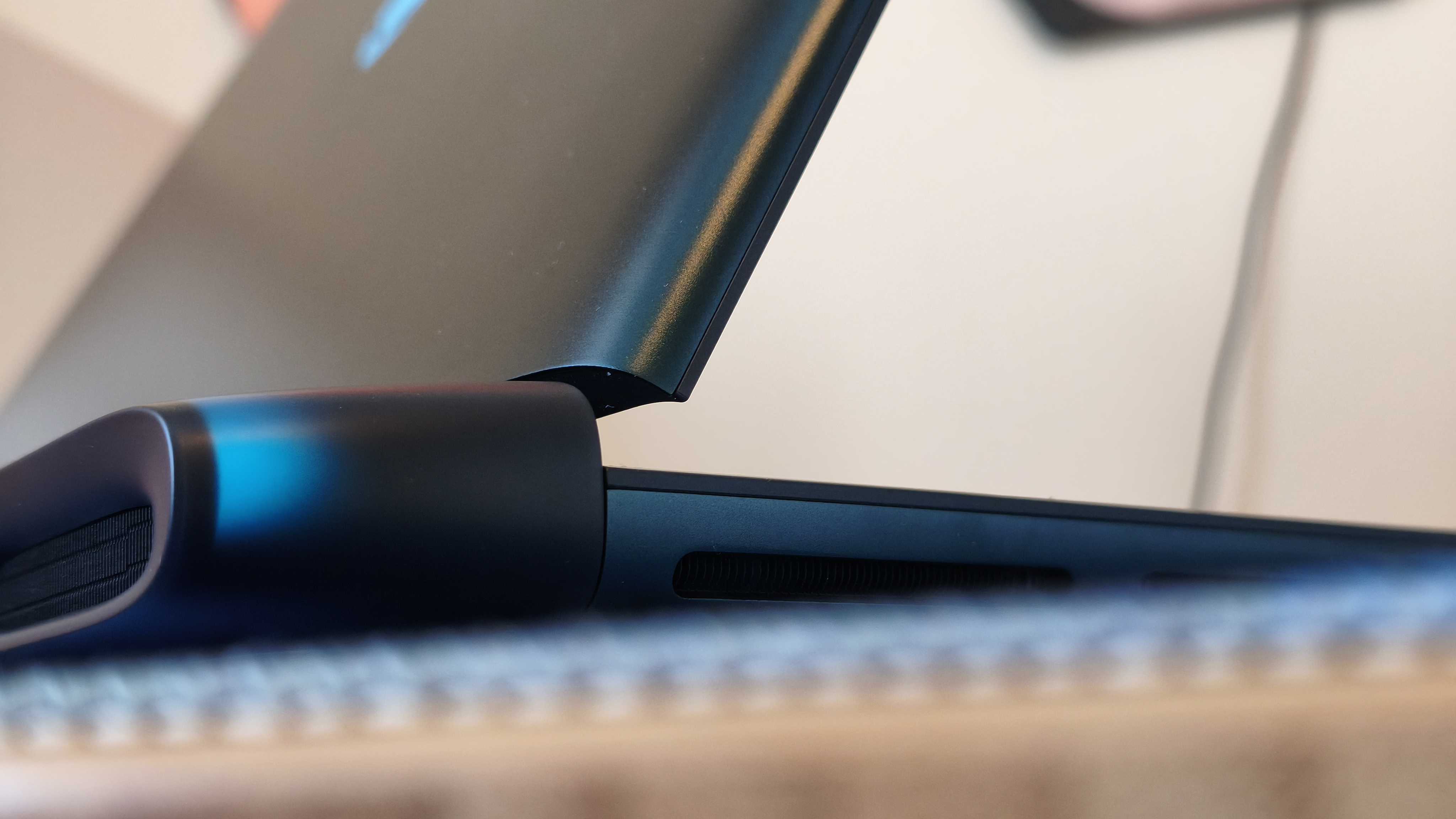 An Alienware 16 Area-51 laptop on a wooden desk