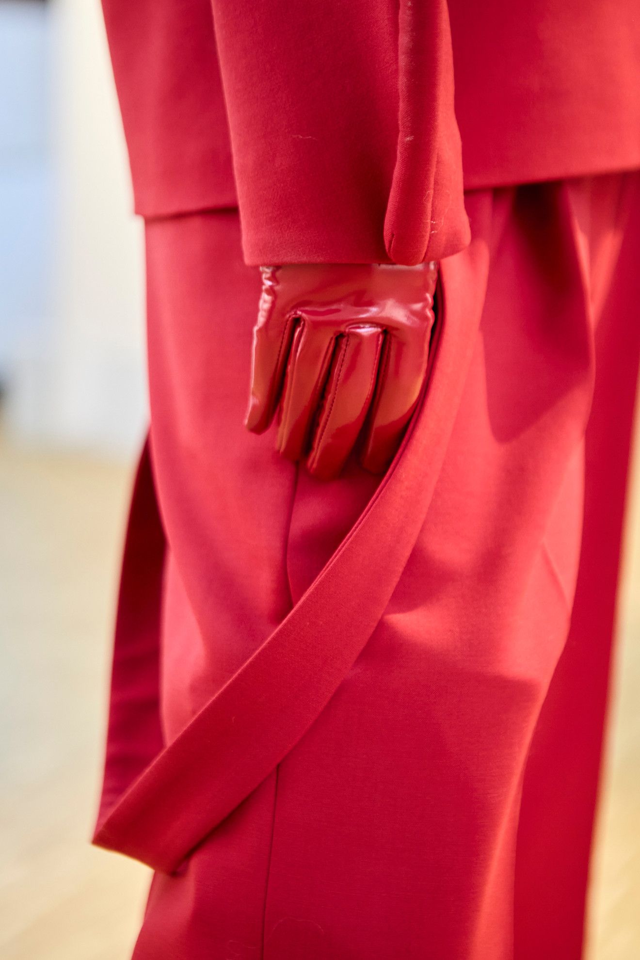Model wearing colored gloves on the runway.