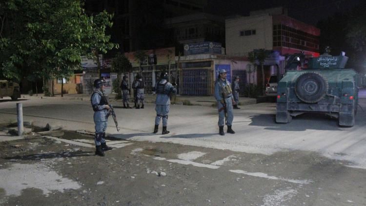 Police outside the Kabul guest house where an American was killed Wednesday.