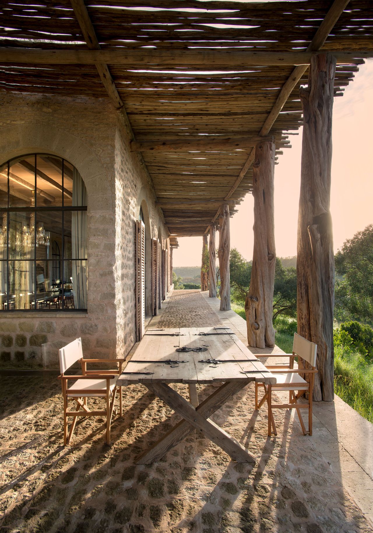 Sheltered patio area with natural stone and logs