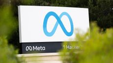 Meta logo and branding pictured on a sign at the entrance to the company's global headquarters at One Hacker Way in Menlo Park, California.