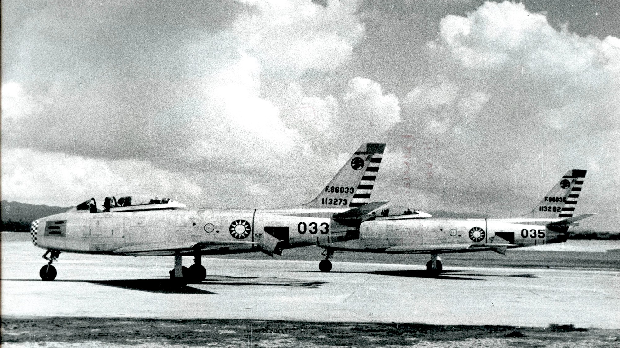Two F-86 Sabre jet fighters on a runway