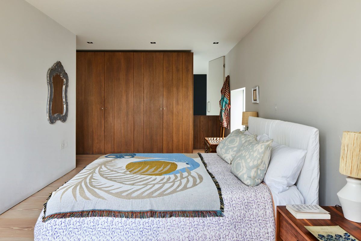 Built-in cabinetry lines the wall of the second floor bedroom