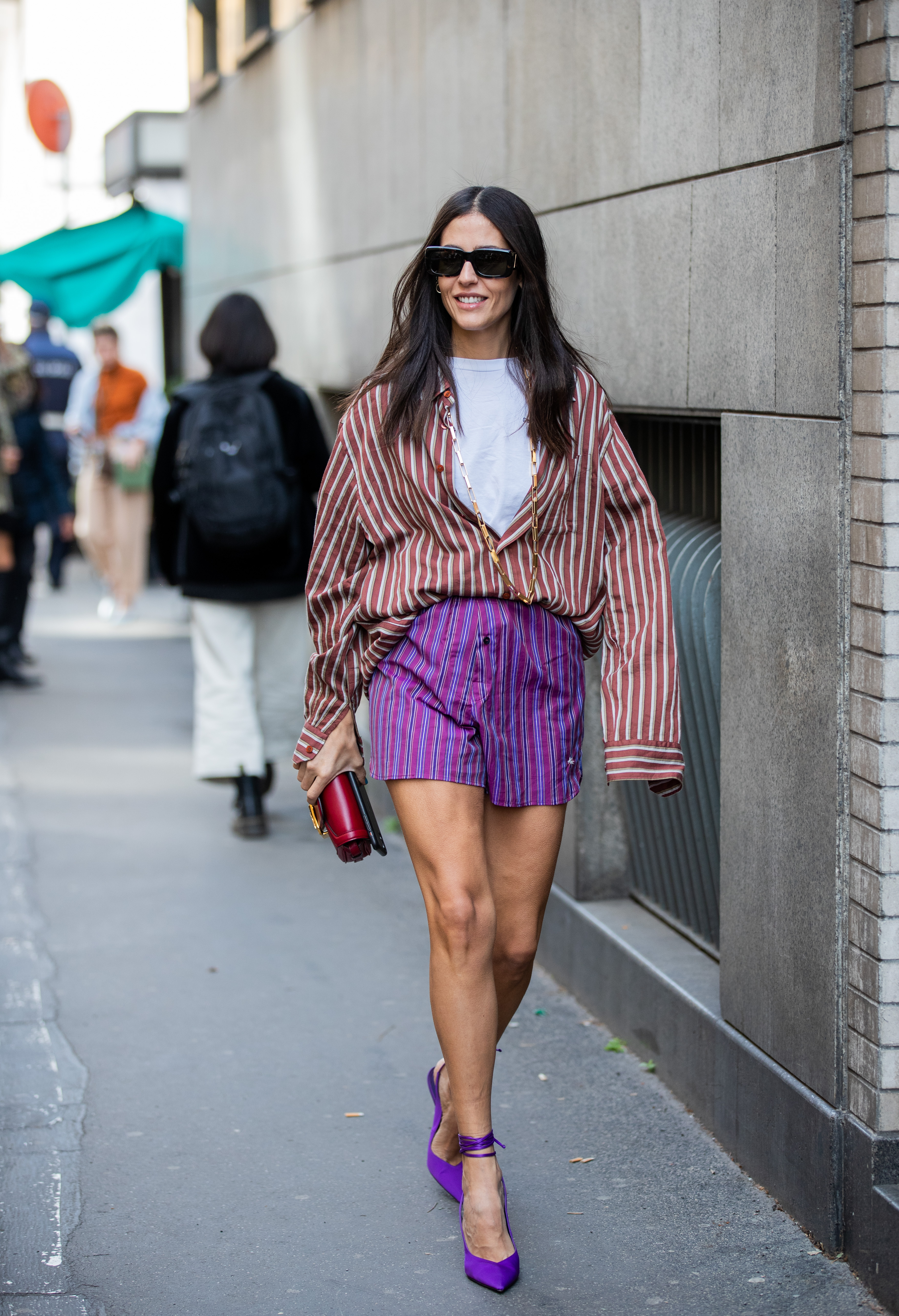Gilda Ambrosio is seen wearing striped puple shorts and button shirt outside Etro during Milan Fashion Week Fall/Winter 2020-2021 on February 21, 2020 in Milan, Italy.