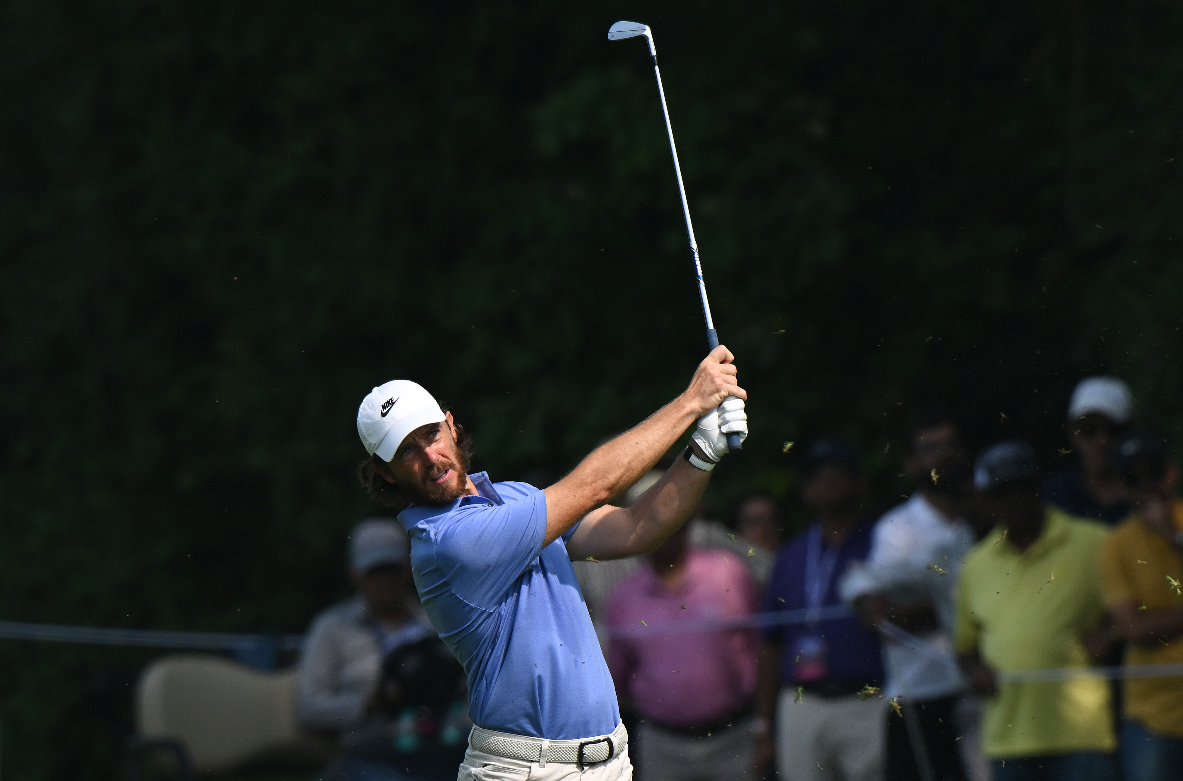 Tommy Fleetwood hits an iron shot