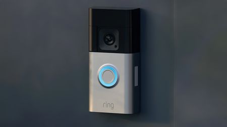 Ring doorbell camera mounted to a dark surface