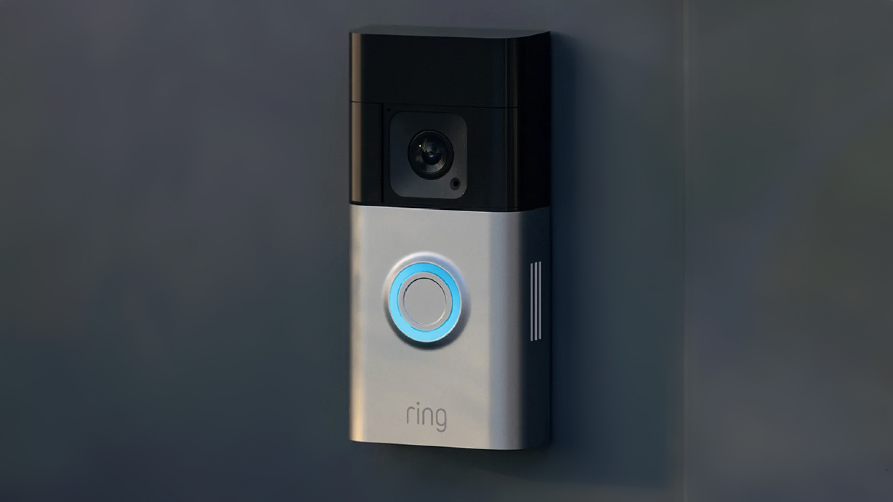 Ring doorbell camera mounted to a dark surface