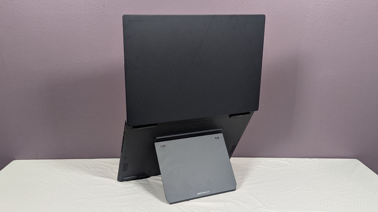 A view of a laptop with two screens from the back, propped up with an attached kickstand.