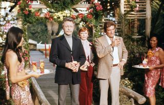 Arnold Greenwood (Bill Bixby) surrounded by other guests in Fantasy Island