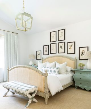 neutral bedroom with French style bed, green and white bench, gwhite lantern, gallery wall and green bedside chest