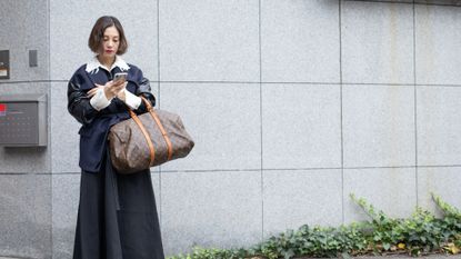 woman carrying a weekender bag