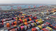 Trucks carry containers at a yard at the Nanjing Port Longtan Container Terminal in Nanjing, Jiangsu province, China, on February 4, 2025