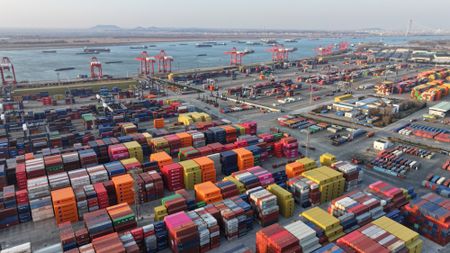 Trucks carry containers at a yard at the Nanjing Port Longtan Container Terminal in Nanjing, Jiangsu province, China, on February 4, 2025