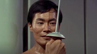 Sulu looking at his sword