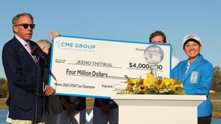 Jeeno Thitikul is given her prize check for winning the CME Group Tour Championship