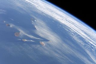 Wispy clouds sweep across the sky over the Canary Islands in this photo by astronaut David Saint-Jacques of the Canadian Space Agency.