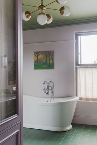 A bathroom with pink walls and green ceiling