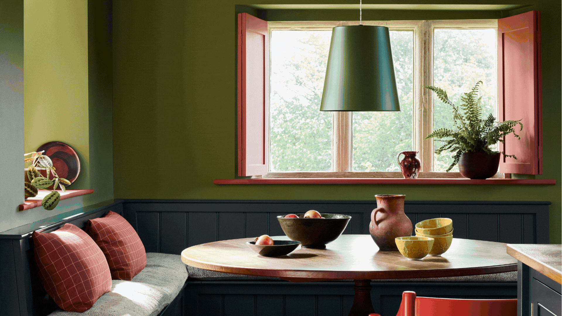Rotating GIF of three images showing very colorful rooms. A green, red, and navy dining nook, a teal and orange bed nook, and a yellow and purple entryway.