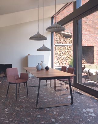 dining room with terrazzo floor and different height pendant lights