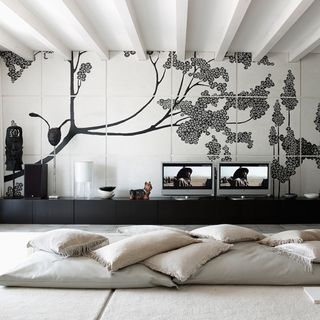 living room with wallpaper wall and cushions