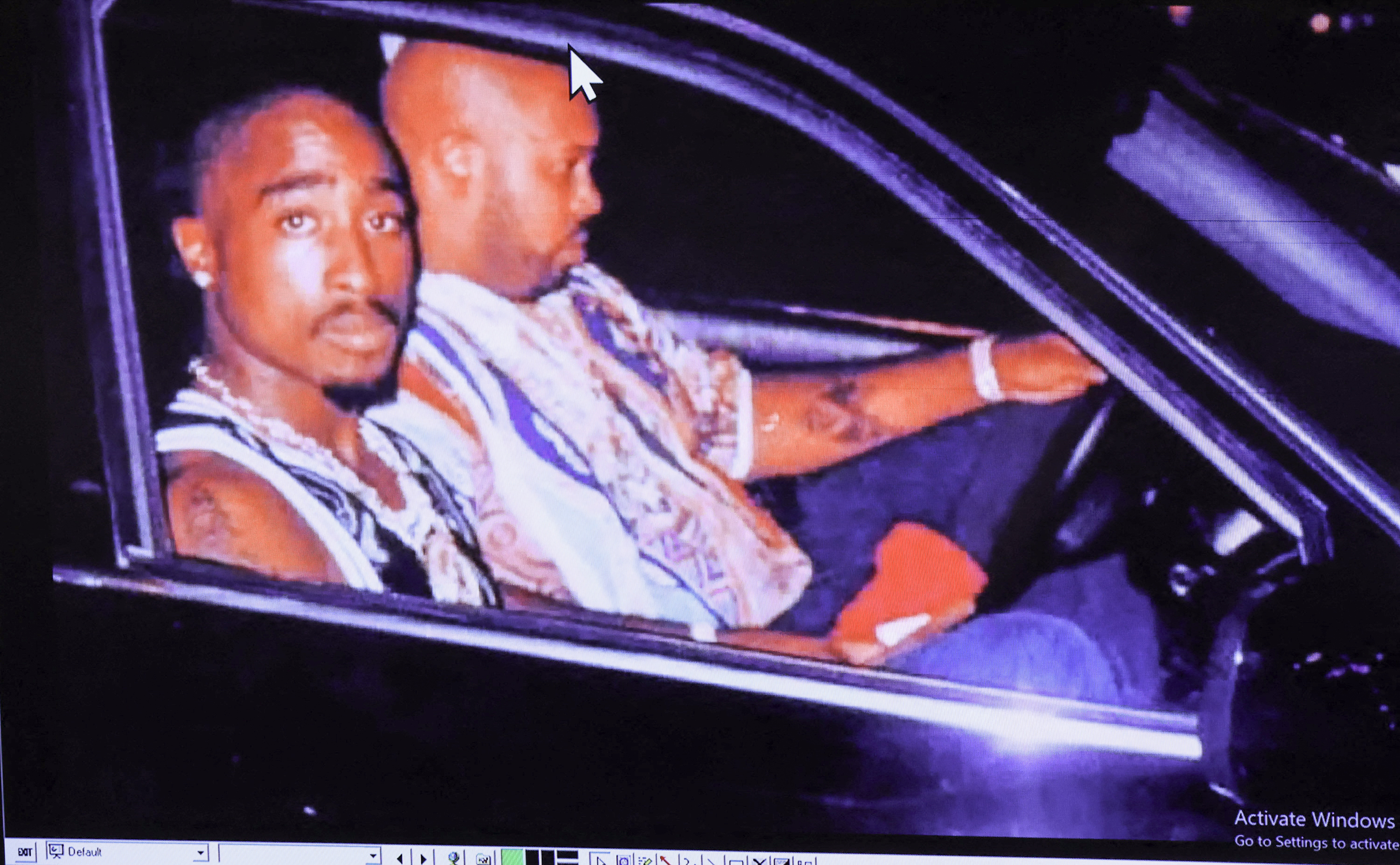 A photograph of rapper Tupac Shakur and Suge Knight, taken by Leonard Jefferson just minutes before the fatal shooting is displayed during the murder trial of Duane Davis, related to the 1996 killing of Shakur, at Clark County District Court at the Regional Justice Center in Las Vegas, Nevada, on August 21, 2026. The trial of the former gang leader accused of orchestrating the murder of rapper Tupac Shakur began on August 10, 30 years after one of America's most high-profile unresolved killings. The proceedings, expected to last a month, will likely not make clear who fired the shots that killed the California hip-hop legend on the night of September 7, 1996, while he was in Las Vegas to see a Mike Tyson boxing match. (Photo by Bizuayeha TESFAYE / POOL / AFP via Getty Images)
