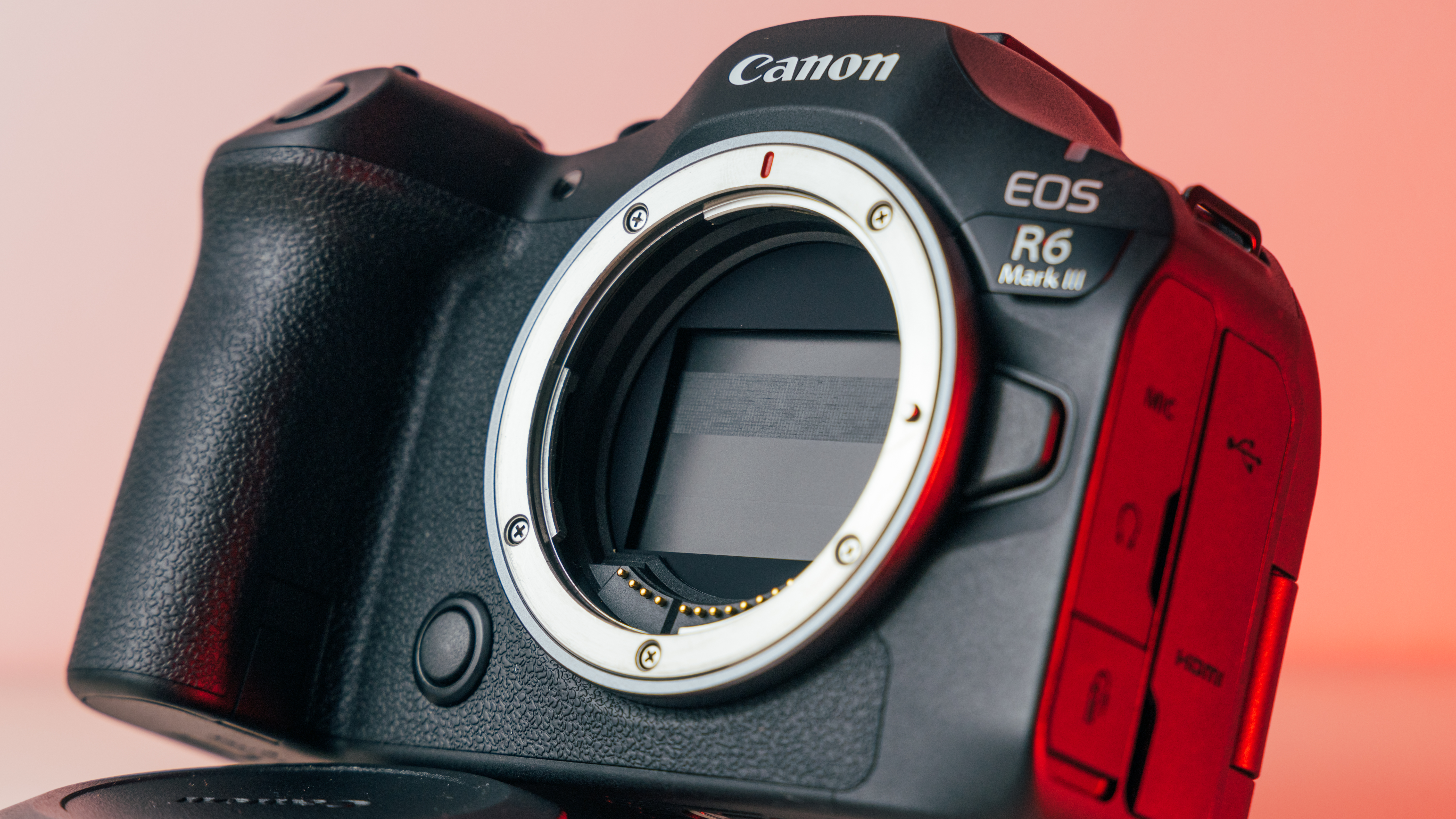 A shot of the R6 Mark III from the front, showing the RF lens mount and protective shutter.