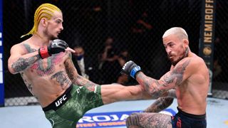 Sean O'Malley (L) kicks Marlon Vera of Ecuador in their bantamweight bout during the UFC 252 event at UFC APEX on August 15, 2020 in Las Vegas, Nevada.
