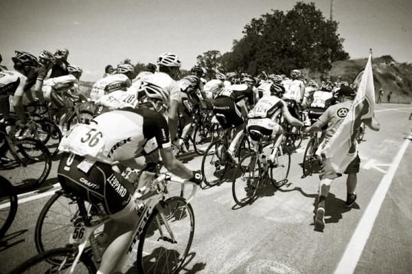 A fan hands up water on the last climb of the day.