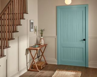 Perfect Backdrop valspar paint color with a blue door in a home's entryway