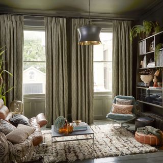 olive coloured living room snug with chairs and curtains