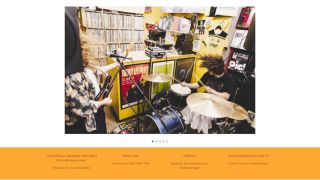 A screenshot of the Google Sites website builder showing someone playing drums in a small room packed with records and posters