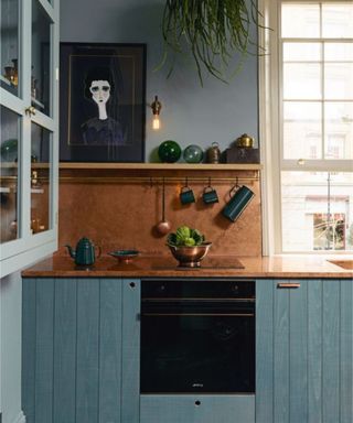Blue kitchen with copper backsplash