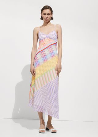 A model wears a dress with several different colored plaid prints by mango