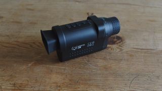 NightFox Cub night vision monocular resting on a table