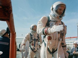 Commander Neil Armstrong (right) and pilot David R. Scott prepare to board the Gemini-Titan 8. Gemini VIII successfully launched at 11:41 a.m. EST, March 16, 1966. The mission conducted the first docking of two spacecraft in orbit and landed safely back on Earth after an emergency abort.