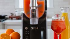 Ninja Slushi in black making a citrus drink