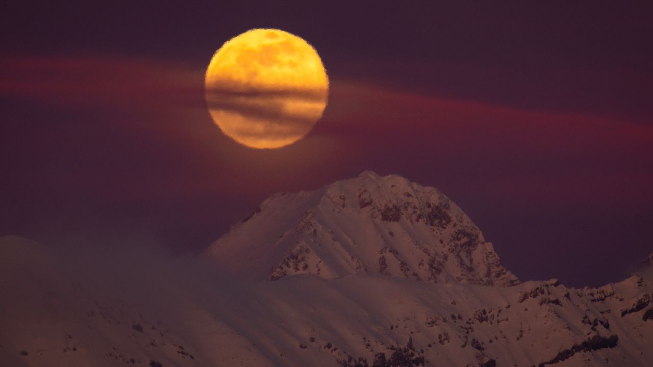 The full snow moon rises behind Corno Grande peaks in Gran Sasso dItalia National Park in L'Aquila, Italy on Feb. 5, 2023.