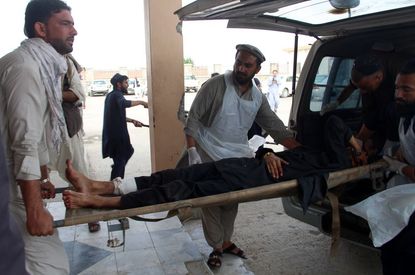 A man wounded in the bombing is put into an ambulance.