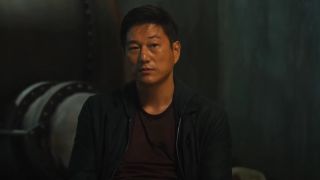 Sung Kang looking ahead in conversation in F9