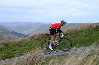 Cyclist Simon Warren climbing out of the saddle on a steep hill