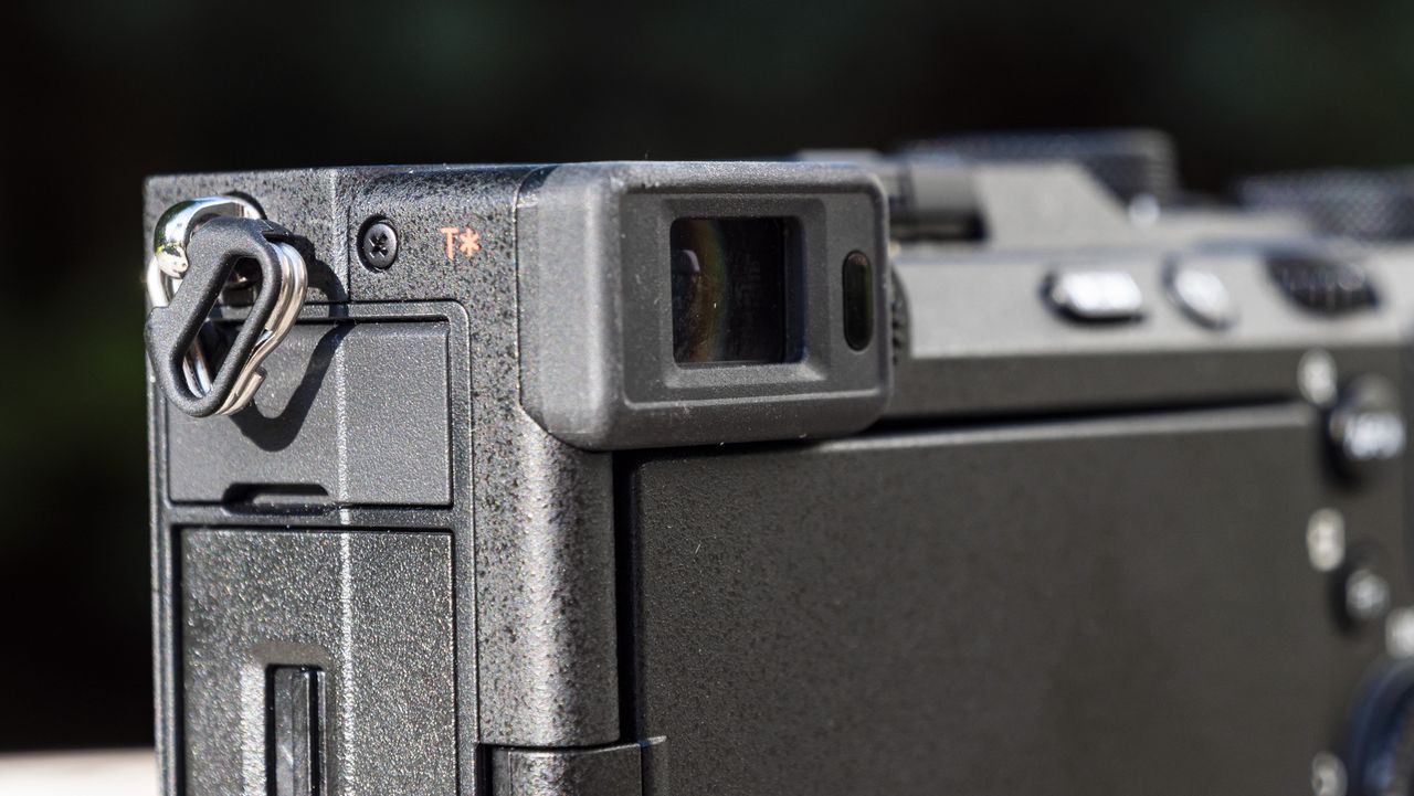 Closeup of the viewfinder of the Sony A7C R camera outside on a wooden table