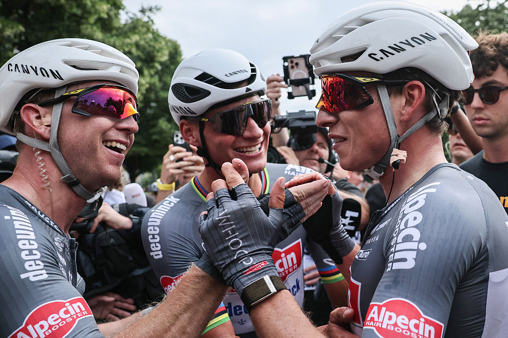 Alpecin - Deceuninck team's Belgian rider Jasper Philipsen (R) celebrates with Alpecin - Deceuninck team's Dutch rider Mathieu van der Poel (C) after winning the 1st stage of the 112th edition of the Tour de France cycling race, 184.9 km starting and finishing in Lille Metropole, northern France, on July 5, 2025. (Photo by christophe petit tesson / POOL / AFP)