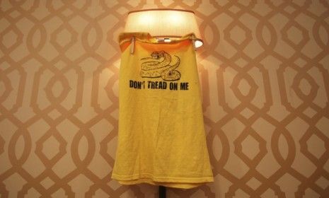 A Tea Party shirt hangs from a lightstand before a Newt Gingrich rally: Because the movement failed to unite behind one candidate, its influence is dimming in the presidential race, say some 