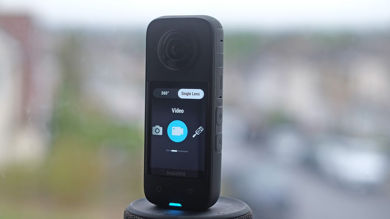 Insta360 X3 on a plynth with blurred cityscape background