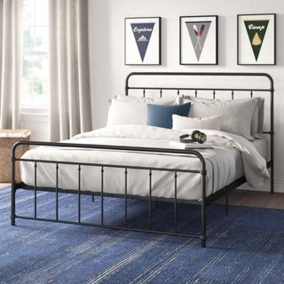 Metal bed frame with white bedding
