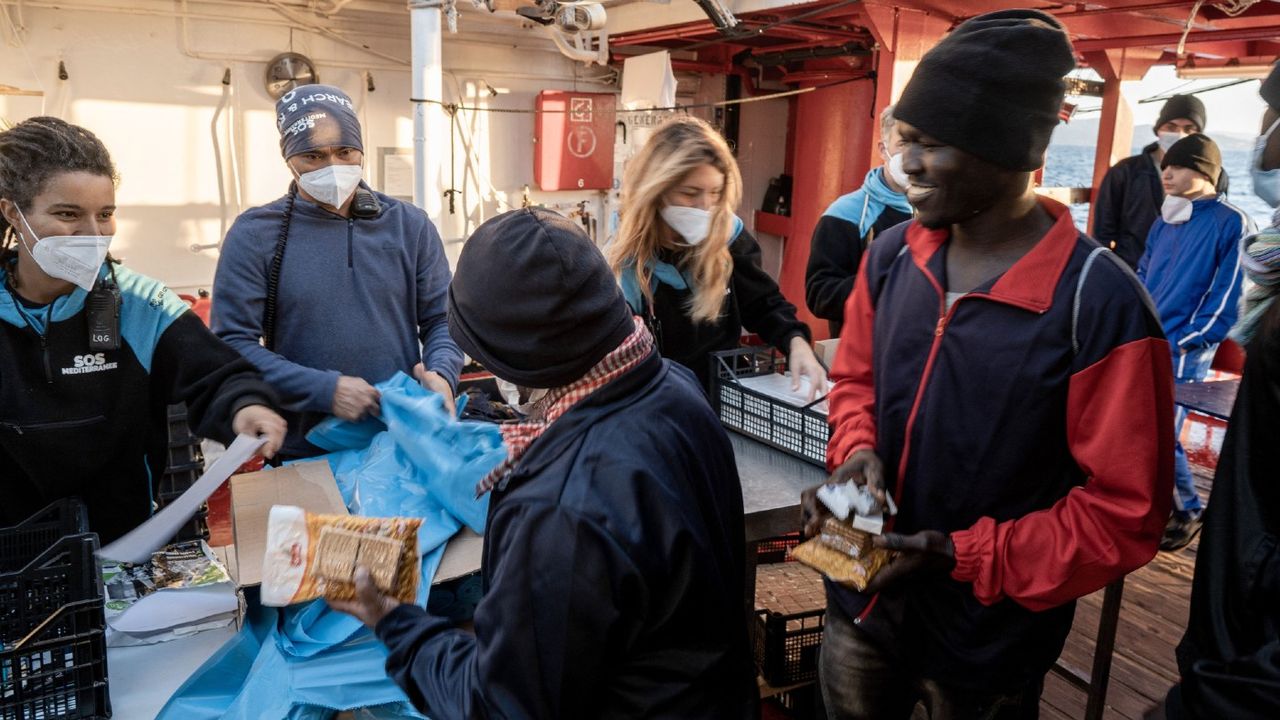 Migrants prepare to disembark from the Ocean Viking