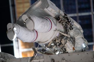 NASA astronaut Christina Koch can be seen with a red stripe on her spacesuit during the first all-woman spacewalk on Oct. 18, 2019.