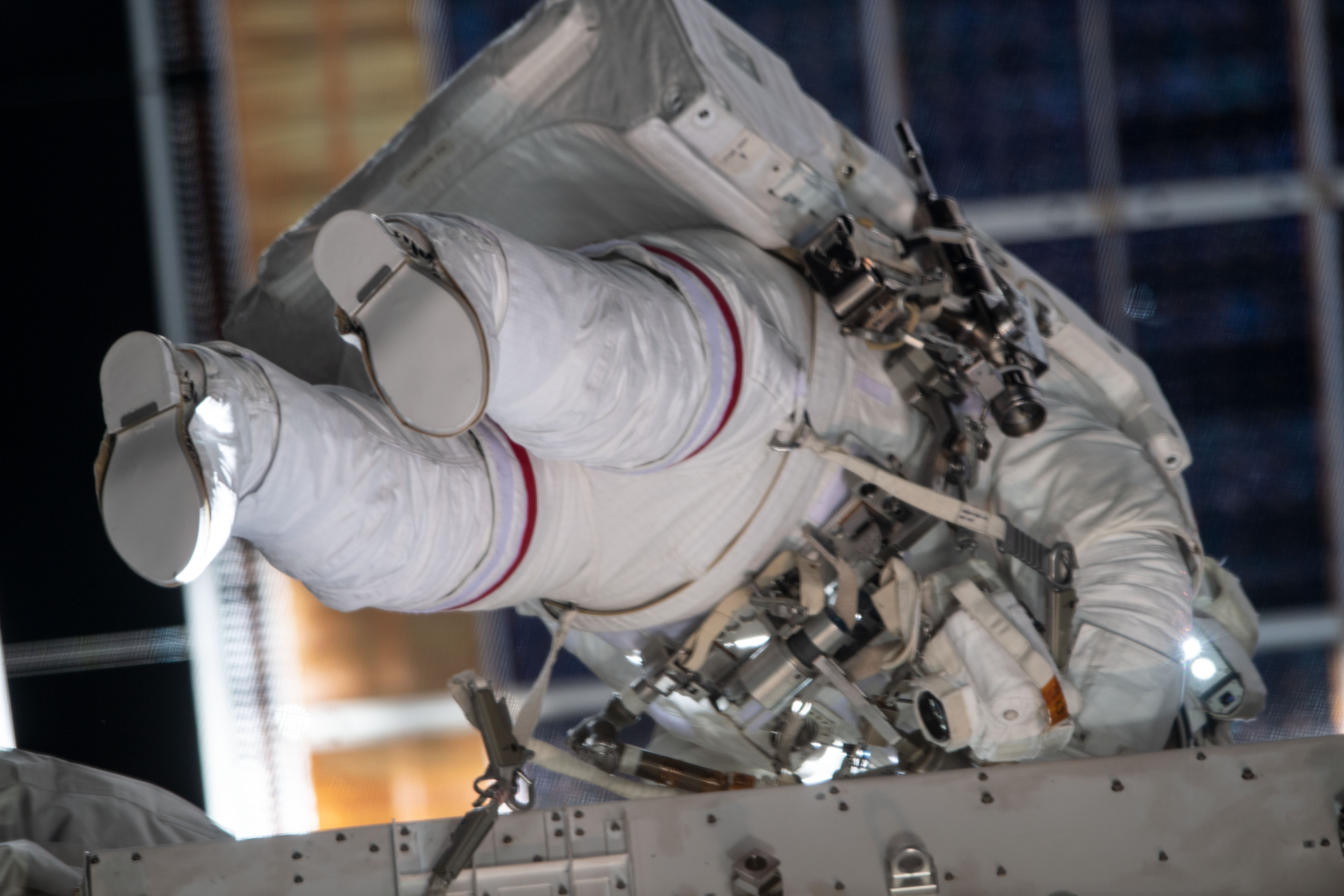 NASA astronaut Christina Koch can be seen with a red stripe on her spacesuit during the first all-woman spacewalk on Oct. 18, 2019. 